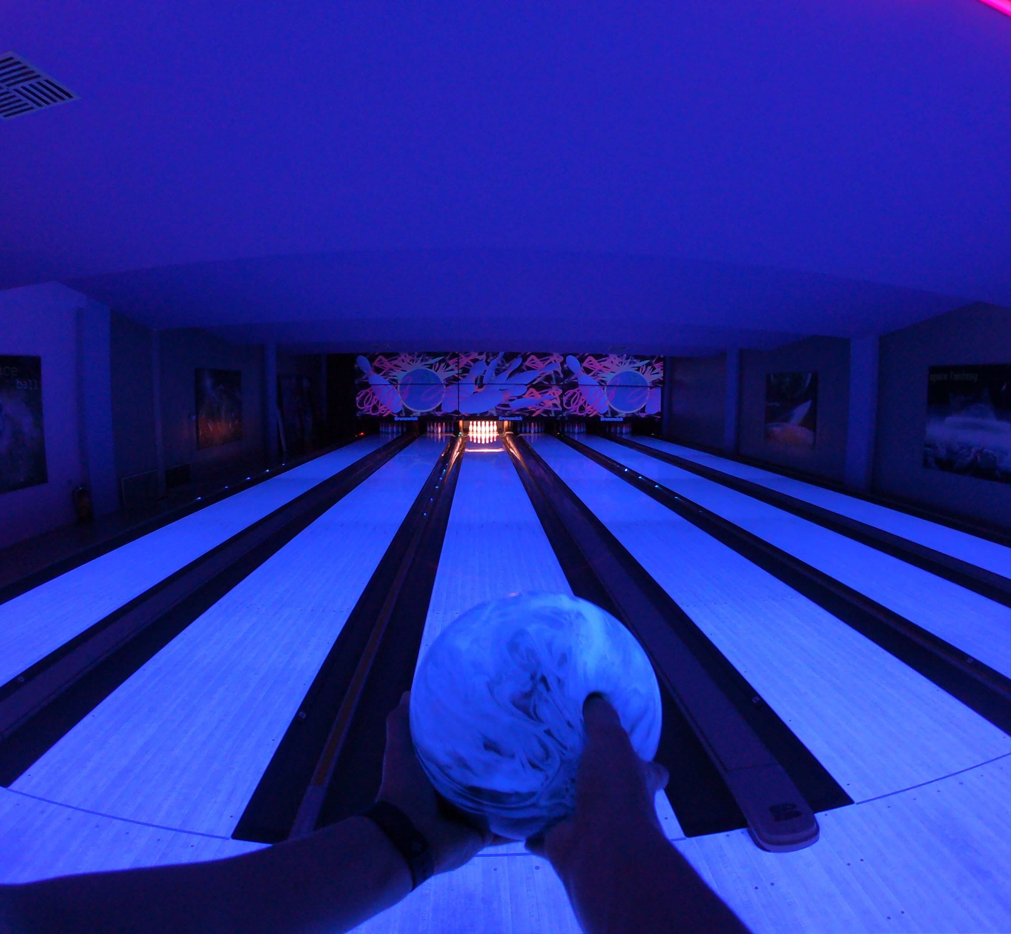 Cosmic bowling lanes at Space Bowling Greece, illuminated with vibrant lights